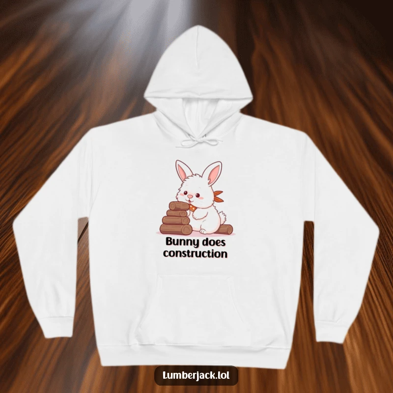 Funny hoodie depicting a fluffy rabbit with a bandana, humorously trying to stack small logs using its nose, a cozy and comical animal illustration.